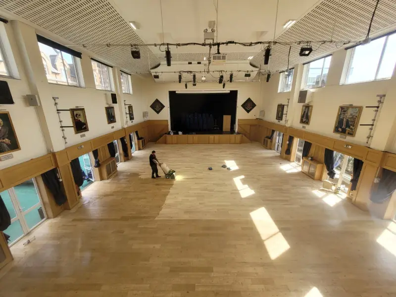 Commercial floor sanding underway on a timber floor in a London hall
