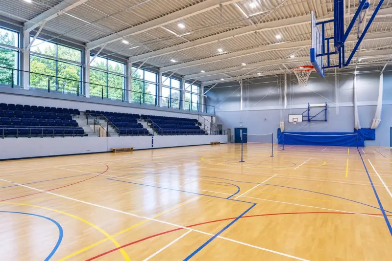 Indoor leisure-centre sports hall with multi-sport coloured court line markings
