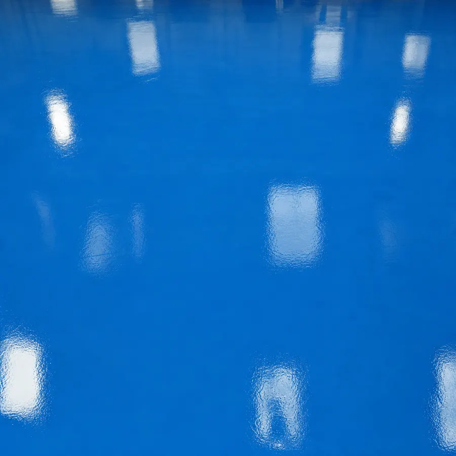 High-gloss traffic-blue epoxy resin floor with a seamless mirror finish